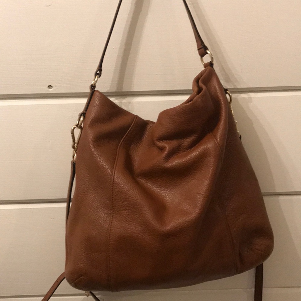 Brown leather Coach hobo style crossbody handbag.
